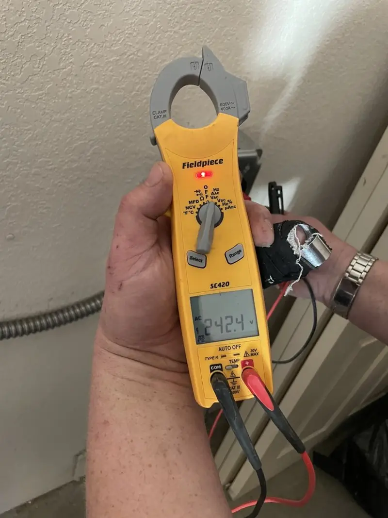 Voltage testing with clamp meter during Generator Installation in Eagle Crest